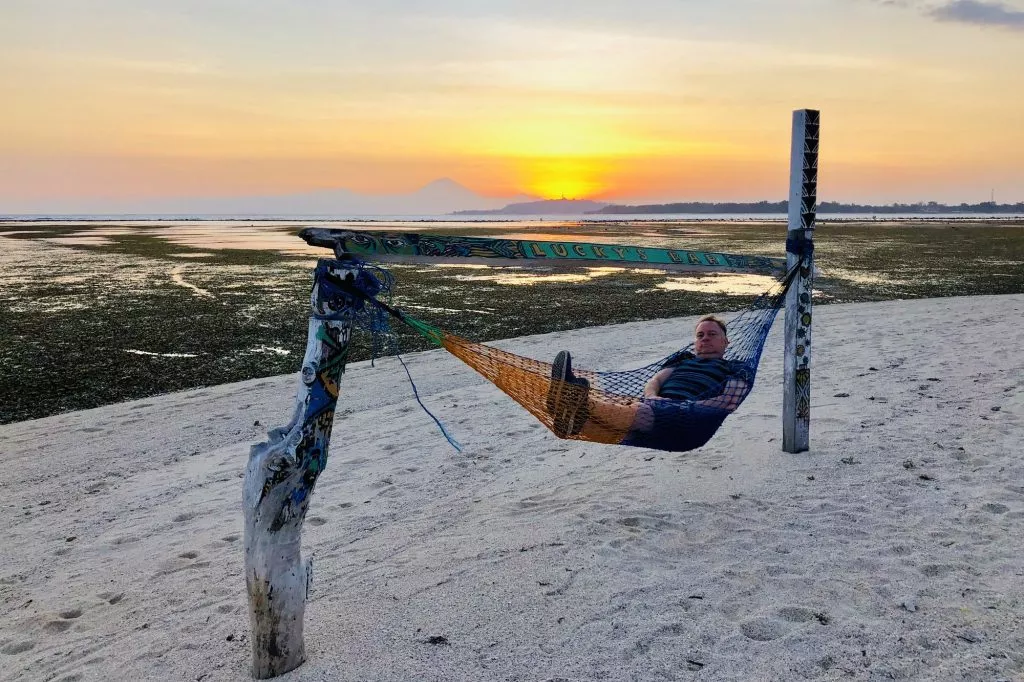 man-relaxing-in-hammock-on-beach-on-gili-island-bali-e1700700227740-1024x682.jpg